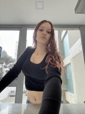 Black top, red hair, and a little bit of mischief