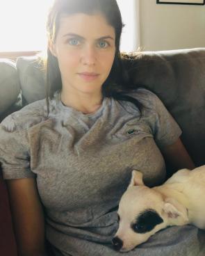 IG: Alexandra lounging on a couch with her dog, 5/8/20