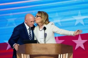Former Congresswoman Gabby Giffords kisses her husband Senator Mark Kelly during her DNC speech