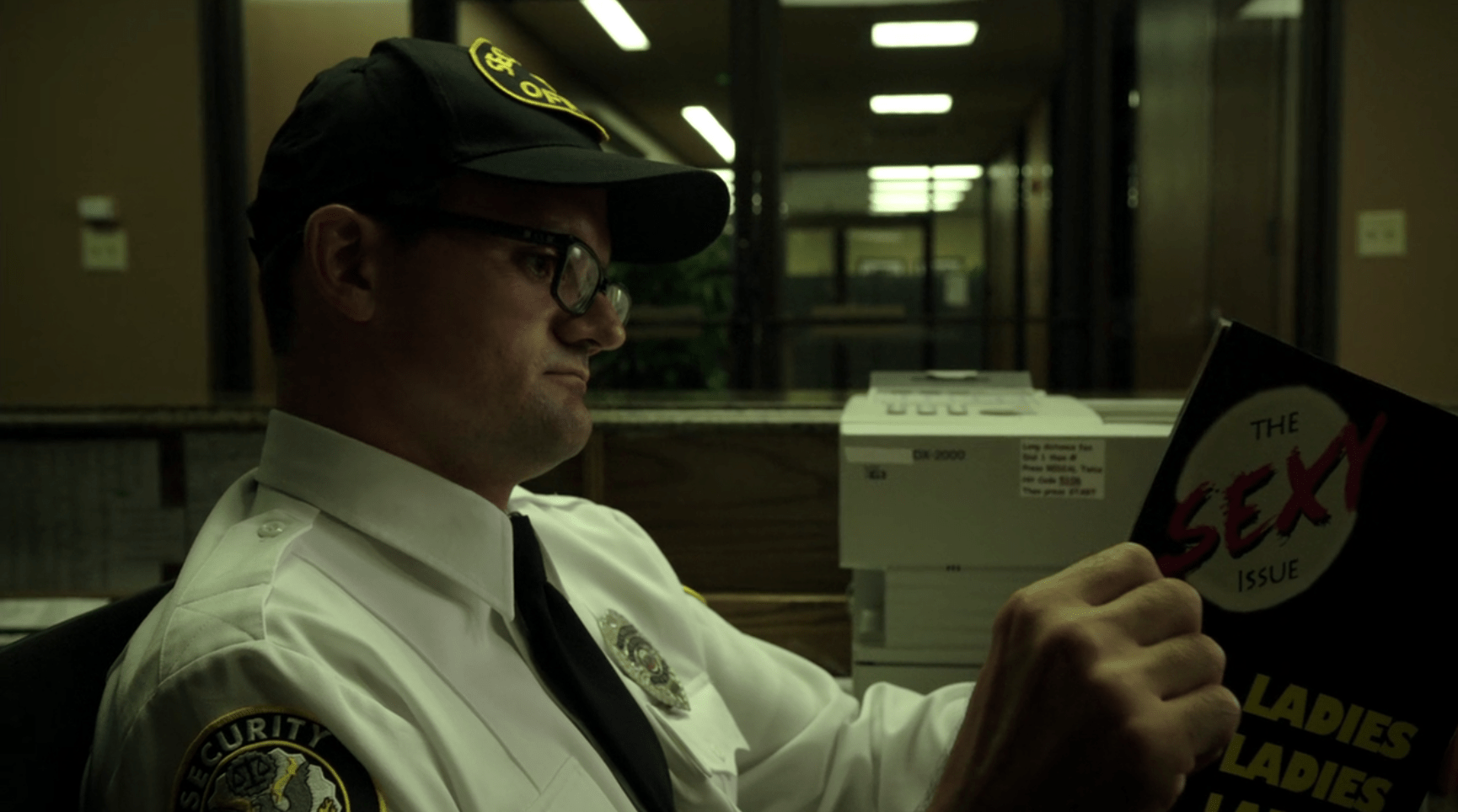 Movie cliche - generic security guard reading a porn mag while the CCTV  monitors behind him show the proantagonist blatantly breaking in. :  rsecurityguards
