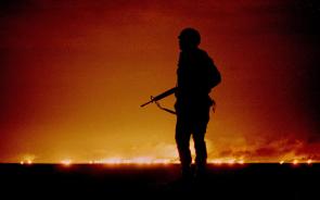 A U.S. soldier standing night guard as oil wells burn in the distance in Kuwait, just south of the Iraqi border during Operation Desert Storm, February 26, 1991. [2000 × 1251]