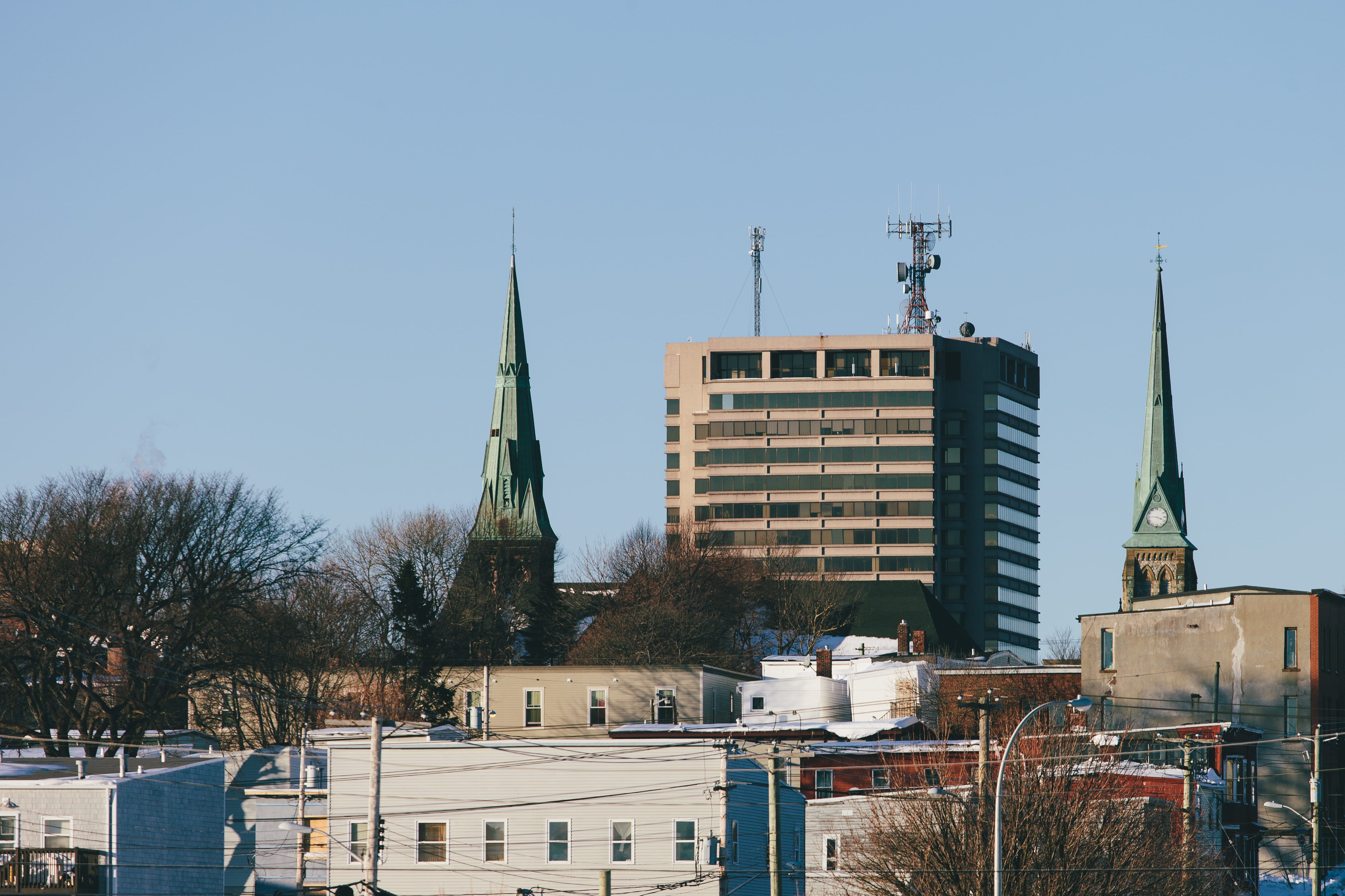 A photograph depicting Bell Aliant Building Between Two Church Steeples Saint John