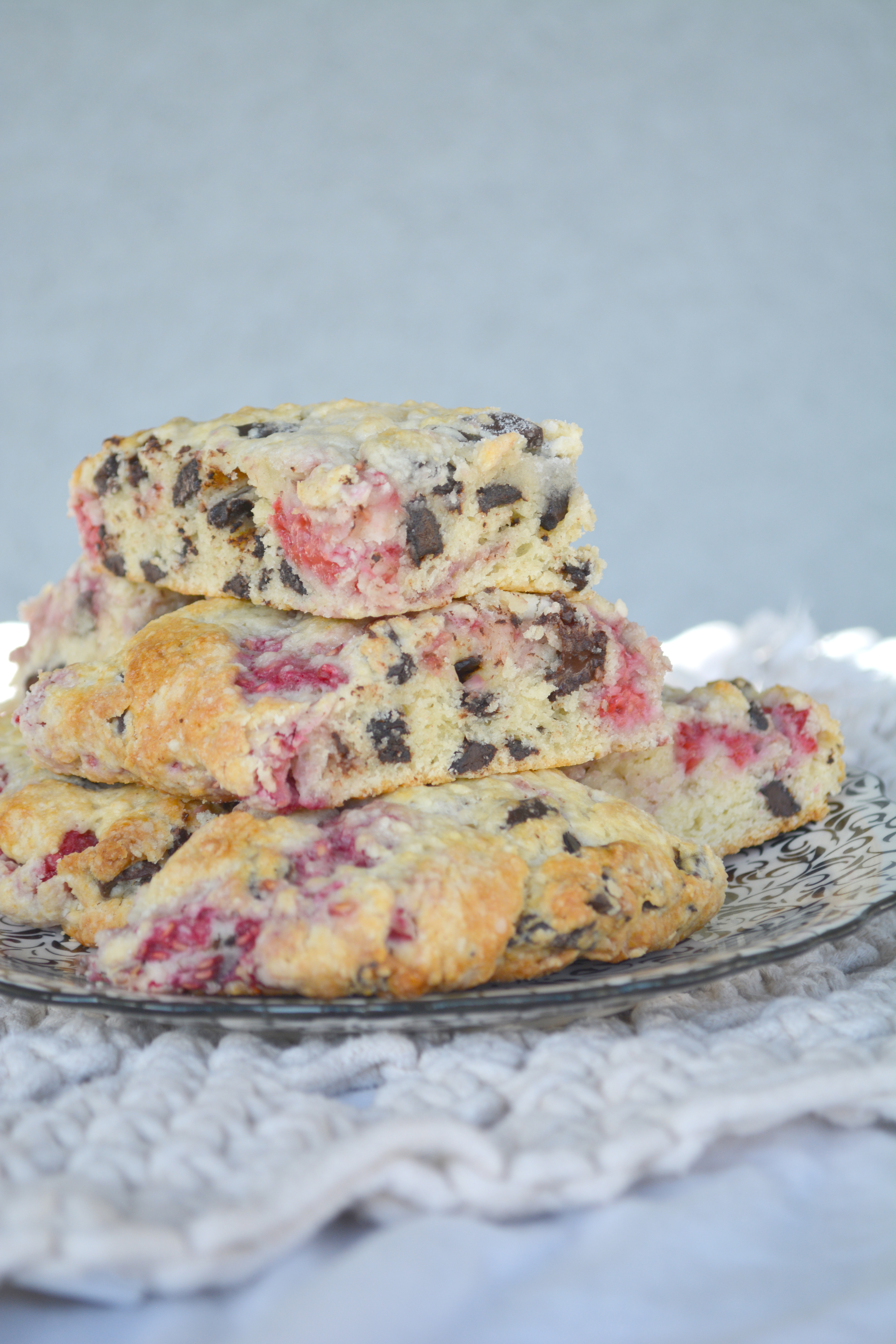 Stack of Raspberry Chocolate Chunk Scones on a black and white plate