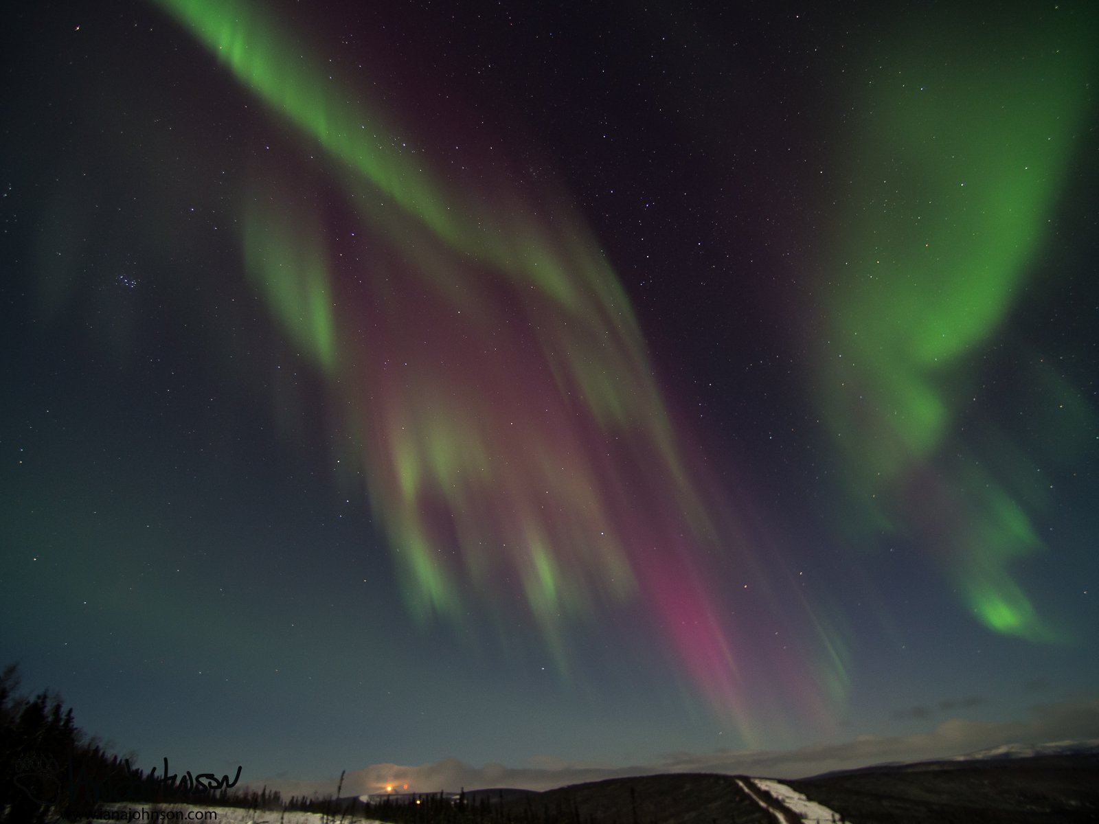 A full sky of red and green over Murphy Dome, Alaska