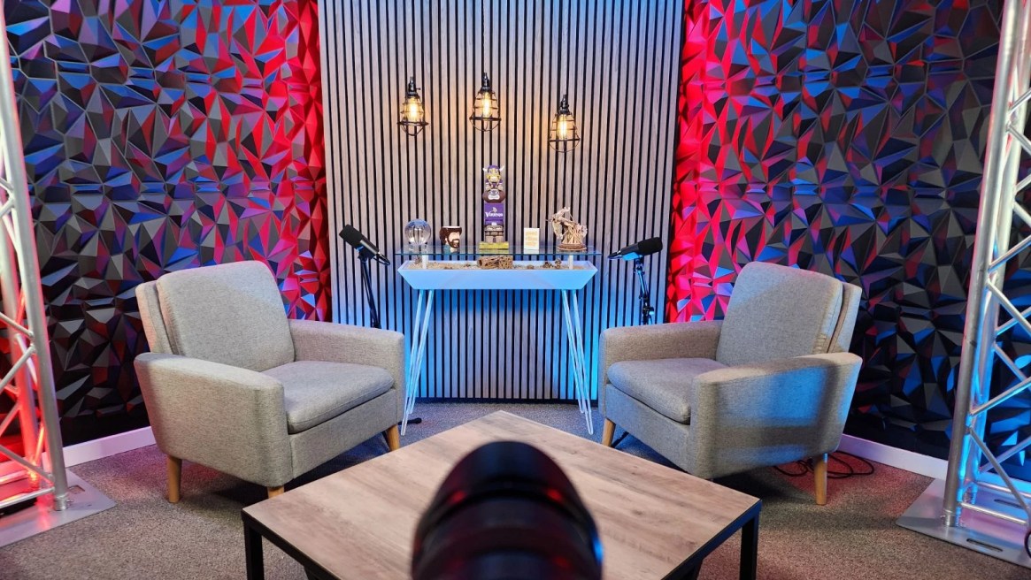 Studio A podcast setup featuring customizable RGB LED backlights, tailored to match your brand's colors for a cohesive, professional look.