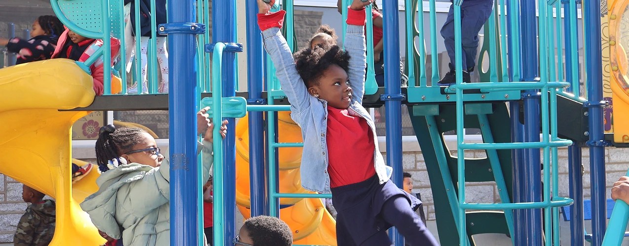 A learner playing on monkey bars