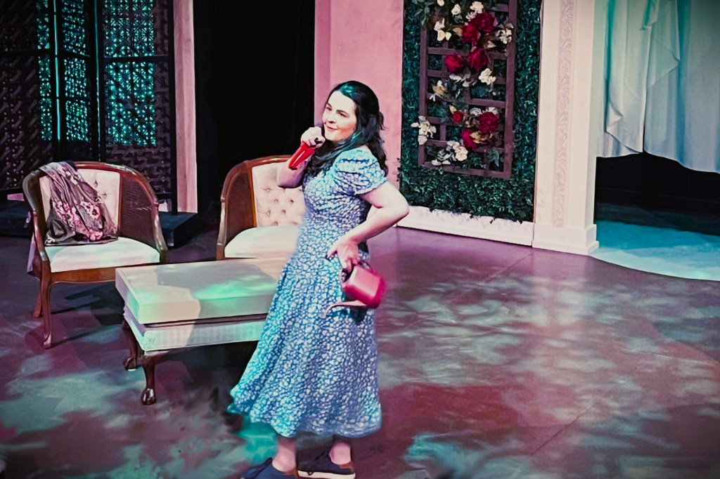 Photo of young woman singing on stage.