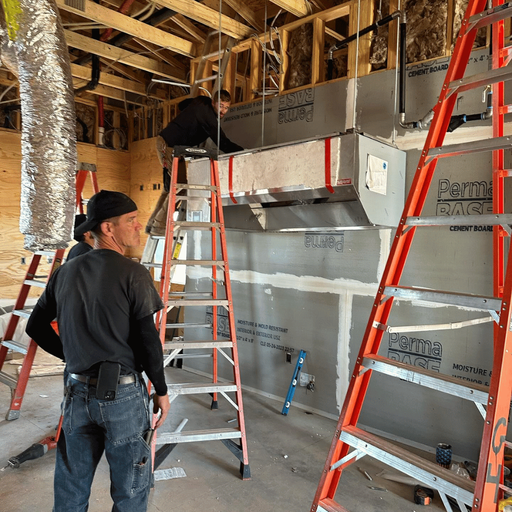Daniel Friedlander, owner of Ideal Builders LLC, reviewing custom home blueprints in the Bitterroot Valley.