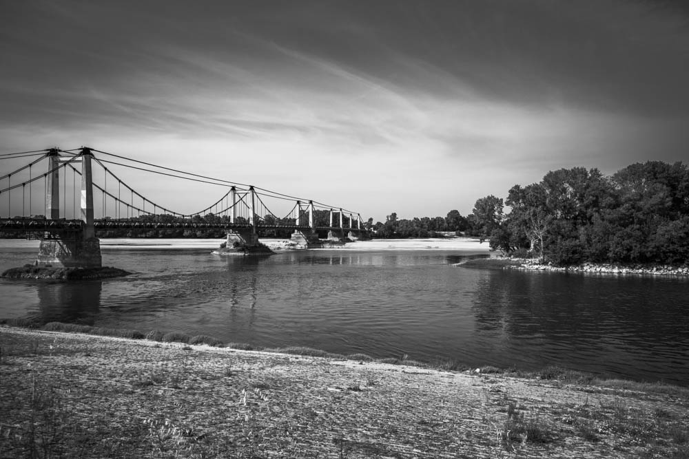 Montjean-sur-Loire suspension bridge over Loire river with dramatic cloud sky, Canon 6D Mark II 16-35mm CPL filter