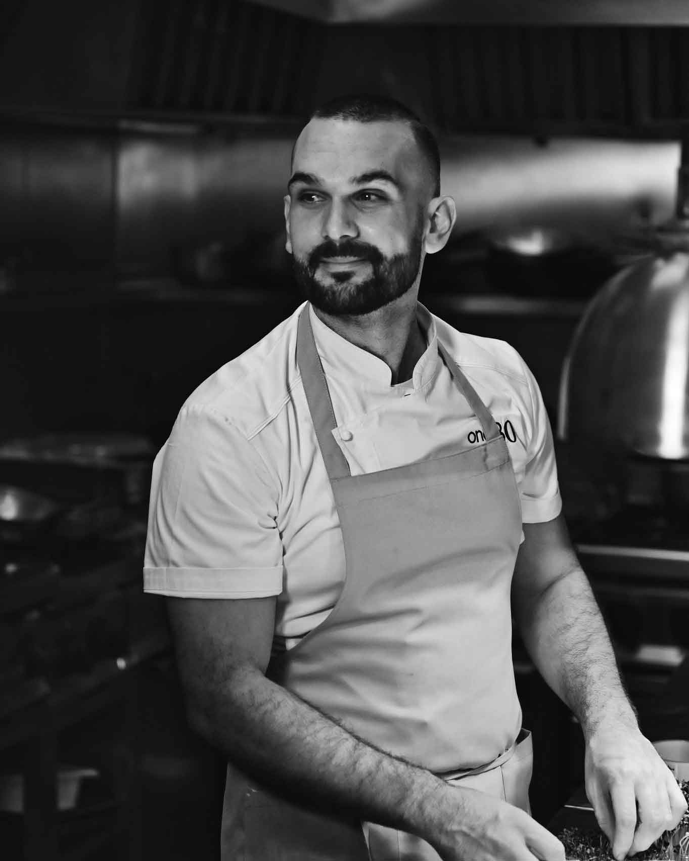 a smiling chef in a commercial kitchen