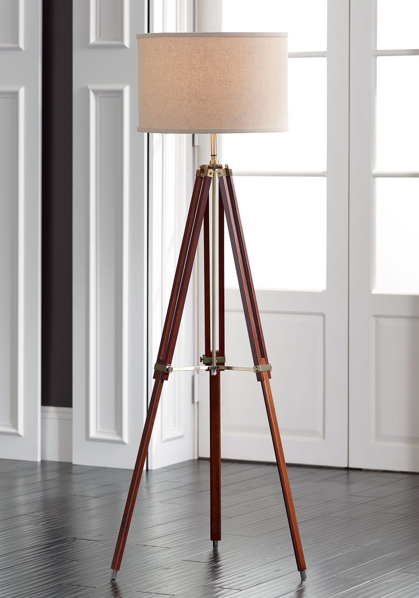 Add instant drama with our photographer's tripod floor lamp, inspired by the golden age of cinema, . Cherry Finish Wood Surveyor Tripod Floor Lamp