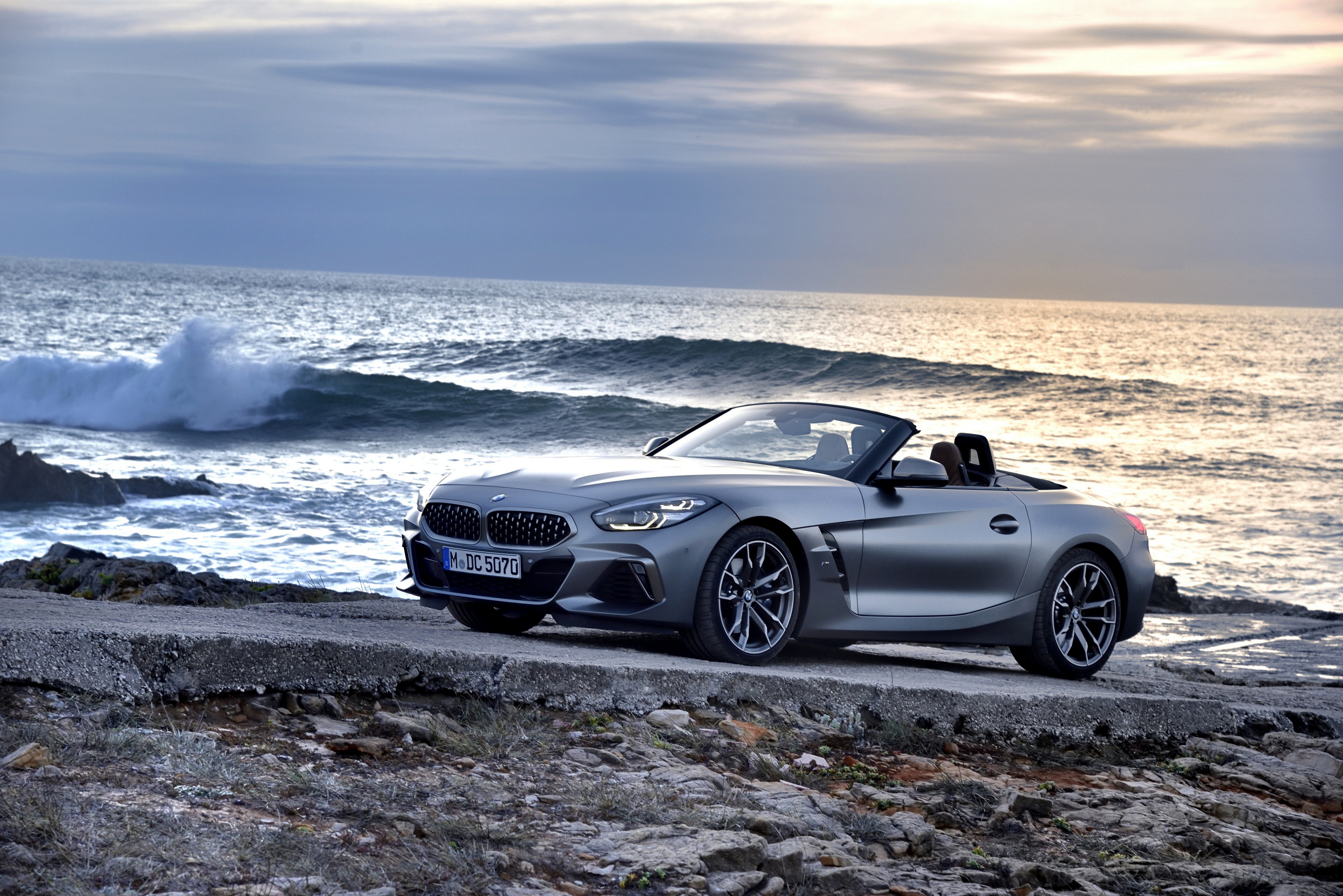 A grey bmw z4 parked near the oceanside