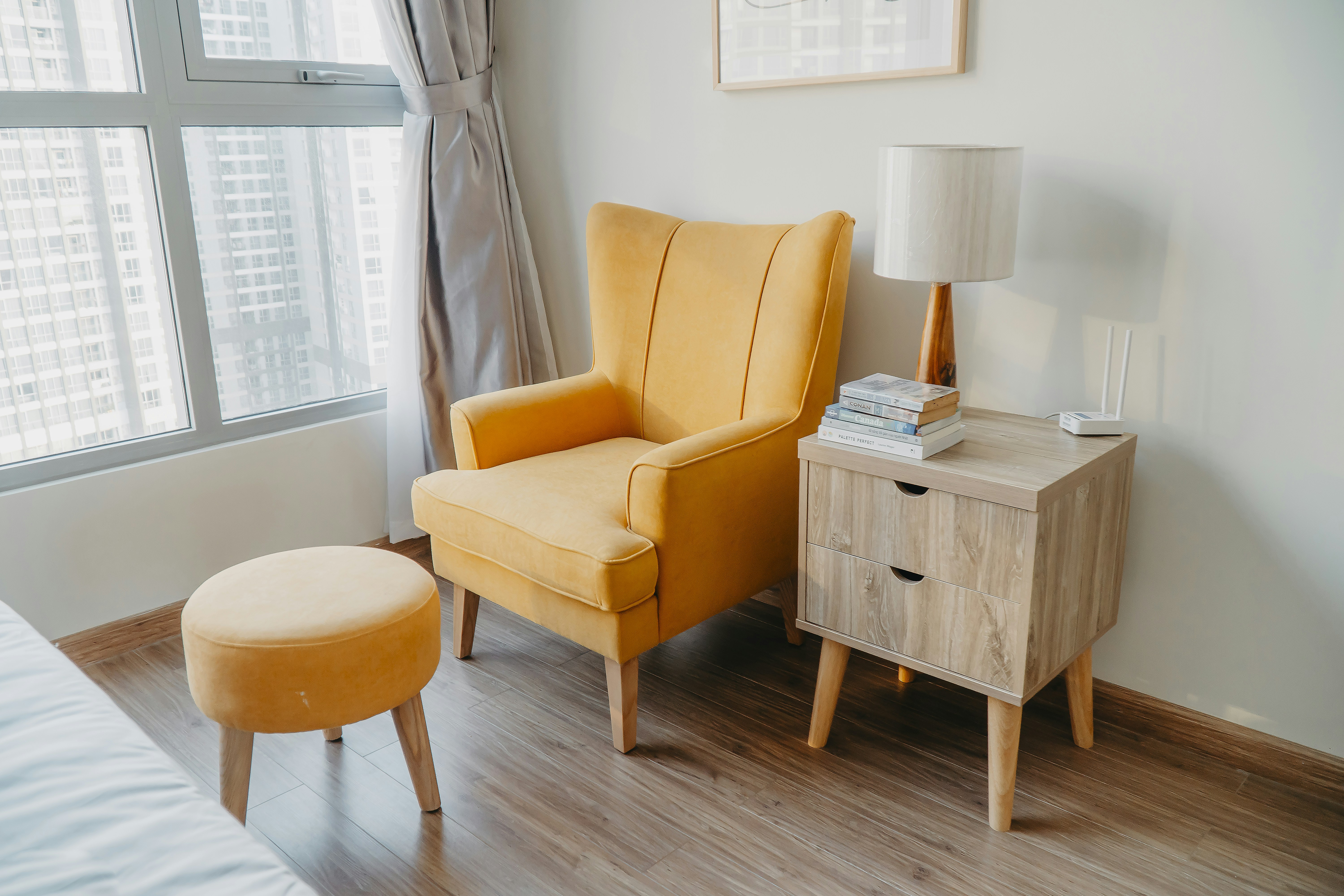 Yellow Armchair And Stool Beside Wooden Nightstand By The Wall Near Glass Window And Bed Photo Free Furniture Image On Unsplash