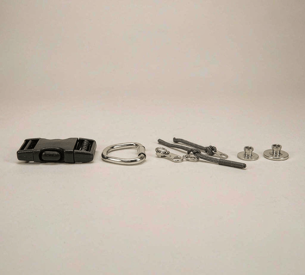 Assorted metal bag hardware: side-release buckles, D-rings, zipper sliders and rivets