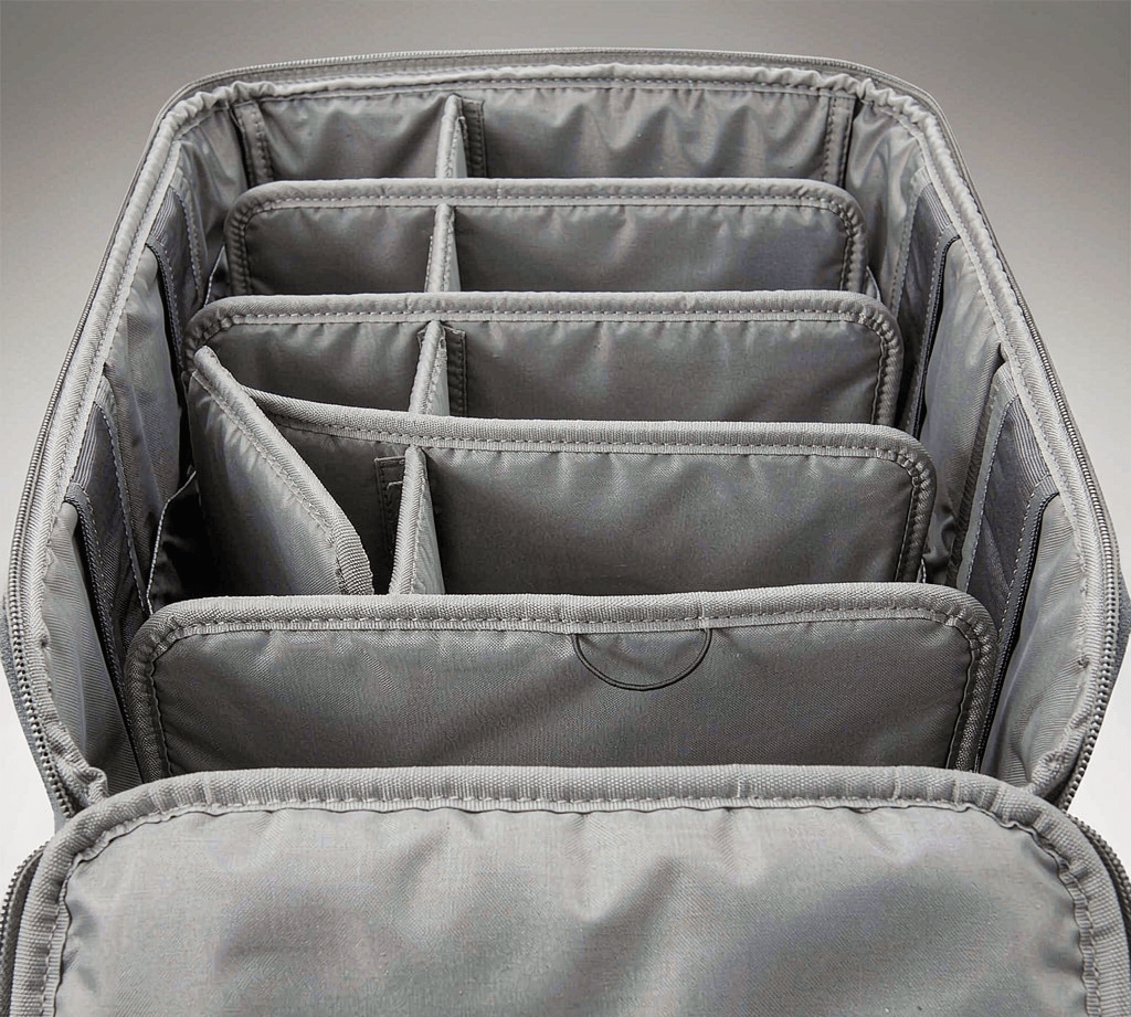 Interior of a soft-sided custom bag showing padded removable internal divider panels forming compartments