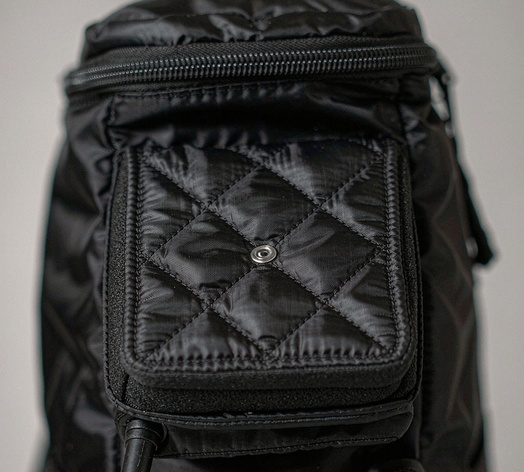 Close-up of diamond quilted padded panel on a backpack showing stitch-through quilting with foam padding