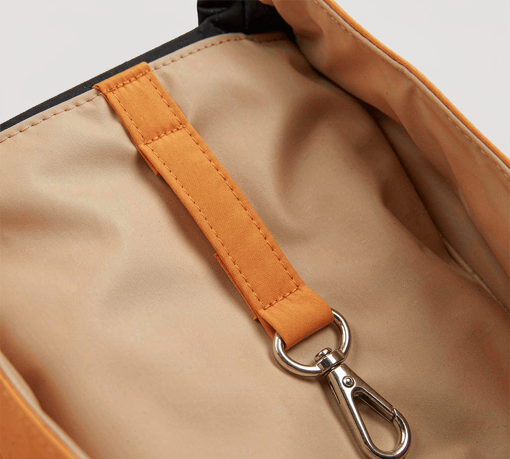 Webbing key leash with a swivel clip anchored inside a tote bag lining