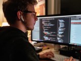 Developer Coding A Responsive Web Page Using Html Css And Javascript