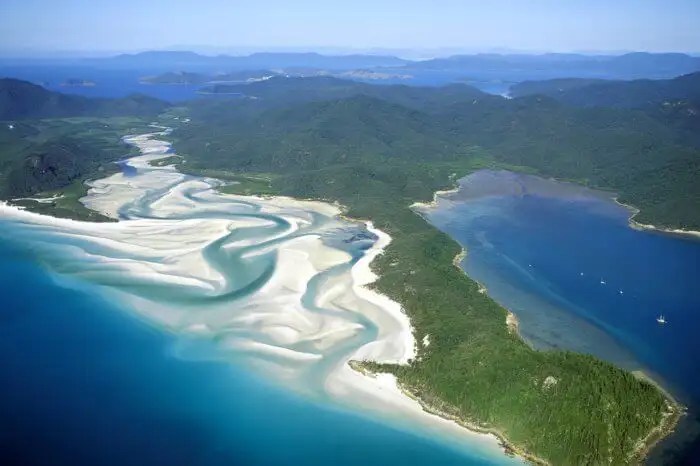 Whitehaven beach is on whitsunday island, australia.the island is accessible by boat, seaplane & helicopter from airlie beach, as well as hamilton island.it lies across from stockyard beach, better known as chalkie's beach, on haslewood island.the beach is known for its crystal white silica sands and turquoise coloured waters. Whitehaven Beach A Mini Guide To Australia S Sunny Beach