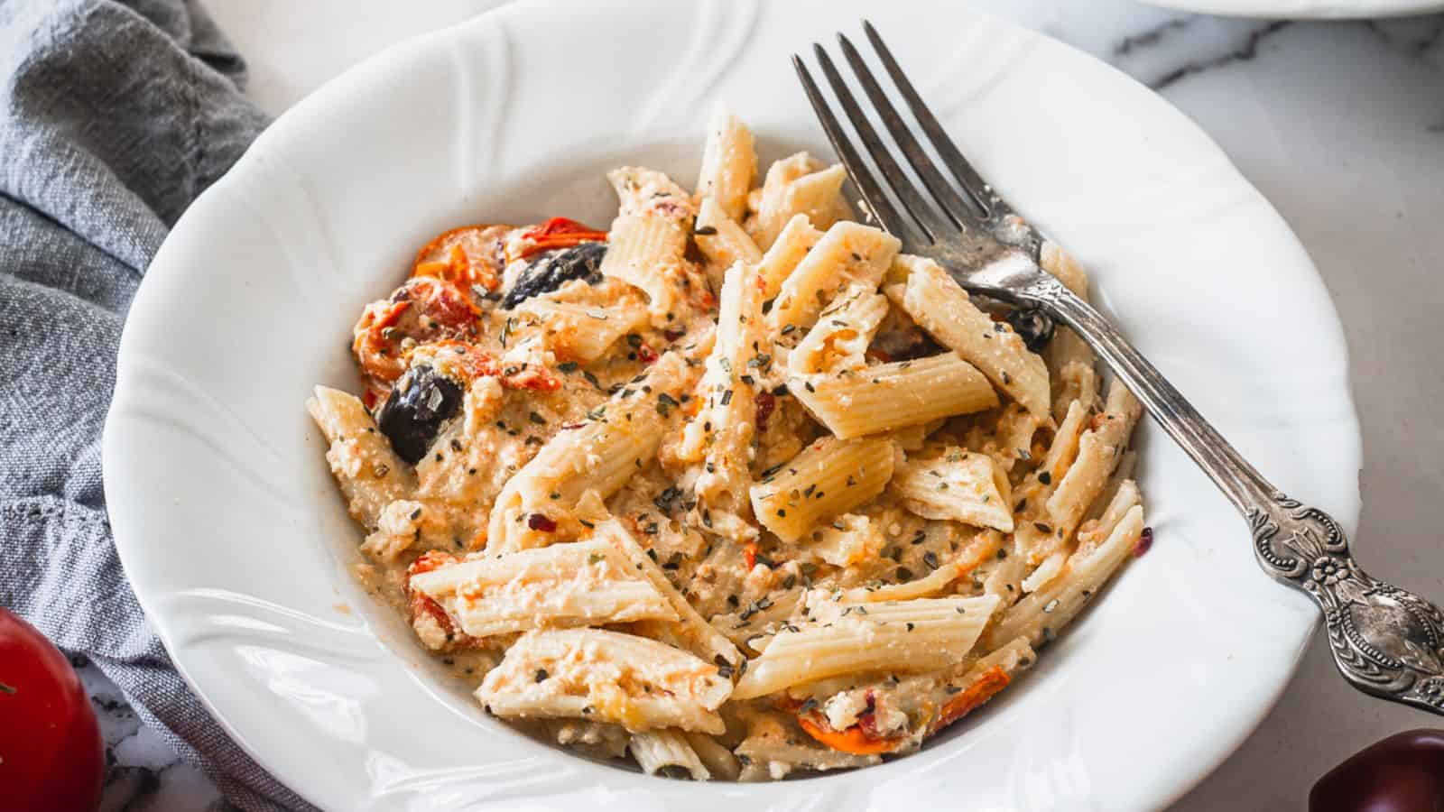 Plate of pasta with feta and fork.