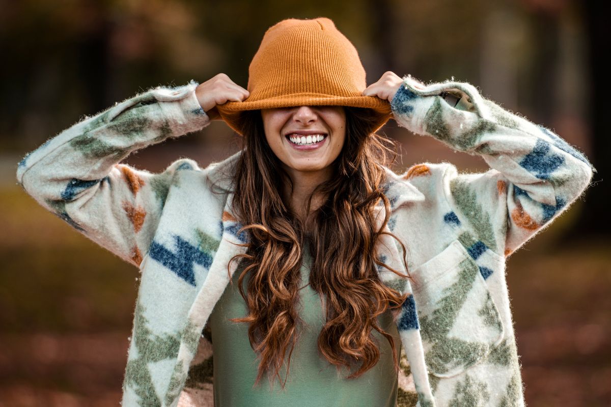 girl pulling down her hat and being funny.