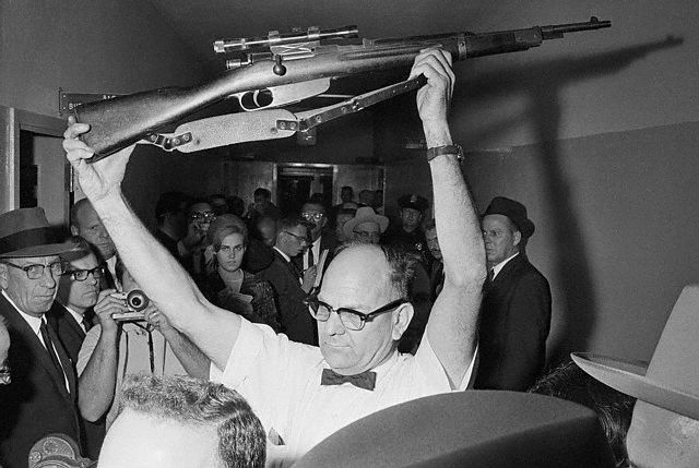 Policeman Holding Rifle Used in Kennedy Assassination