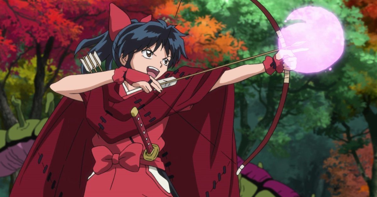 Moroha wearing a red cloak drawing back a bow with a glowing purple magical sacred arrow aimed in a lush forest.