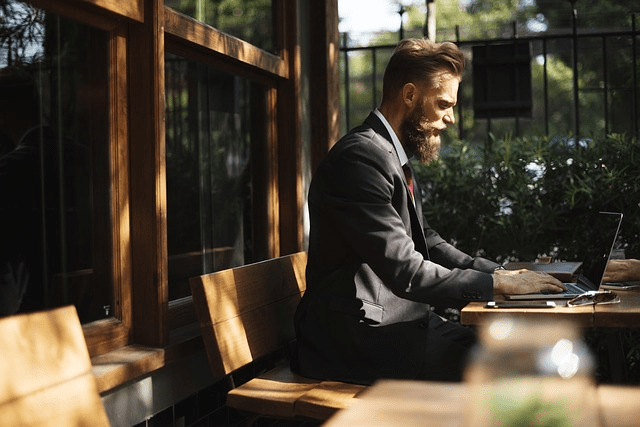 Man working on a laptop sitting at a table