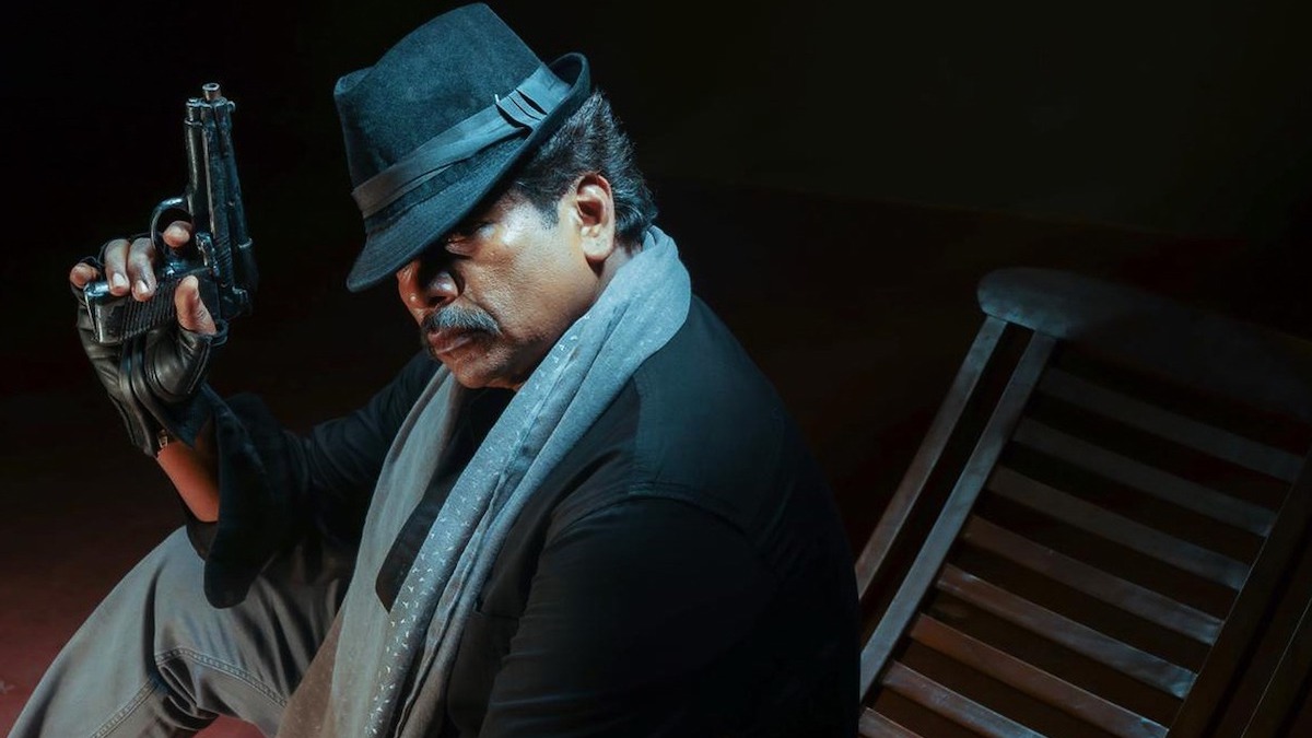 This is a scene from Shadow of the Night. It shows the side profile of a seated man in a bowler hat holding a gun (Image courtesy: Cinequest)