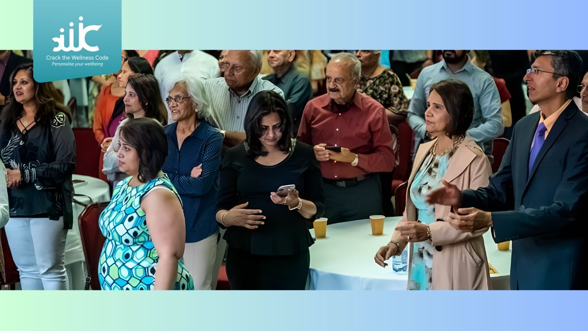 A group of Indian prople applaud speakers at a conference