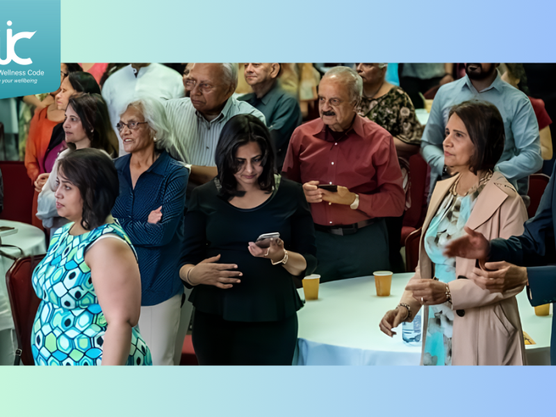 A group of Indian prople applaud speakers at a conference