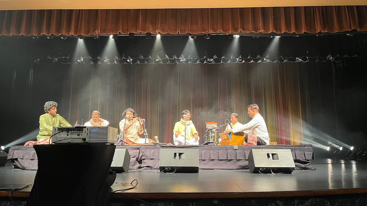Group of Hindustani Classical musicians perform on stage.