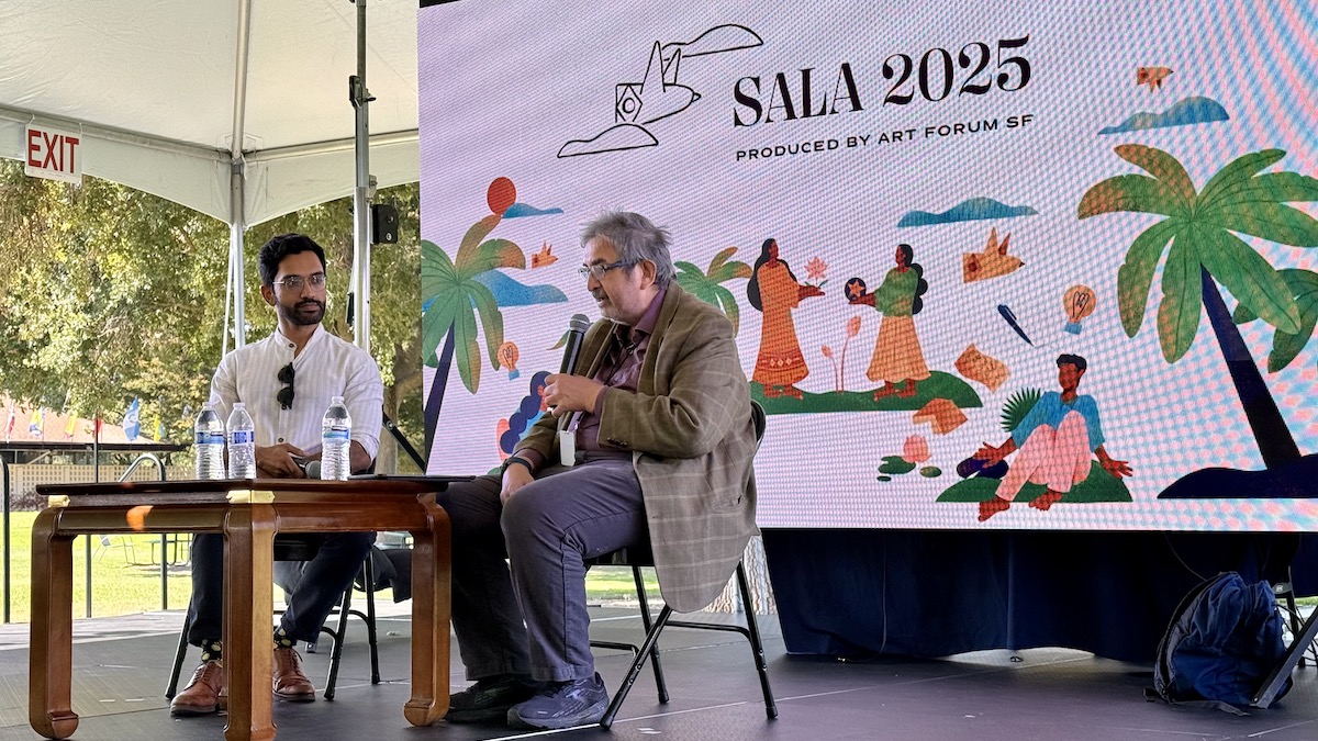 Two men chat at a panel at SALA2025