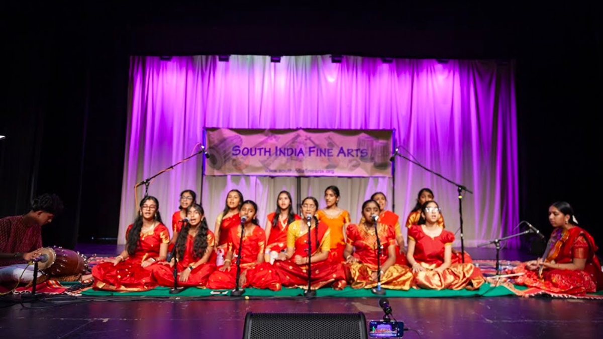 Twelve young women singing the Glory of Dikshitar