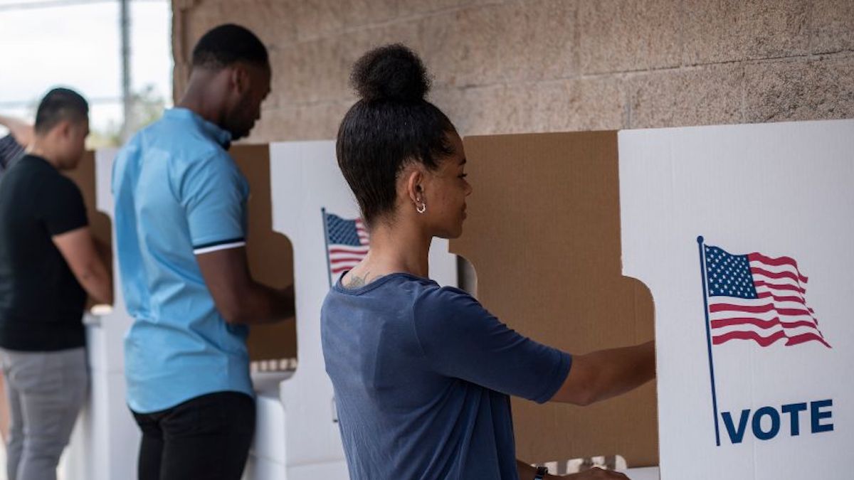 A group of people at voting booths
