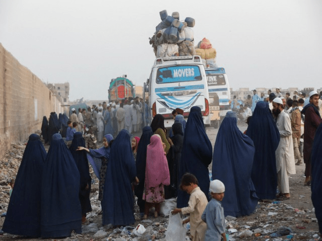 Afgahn returnees walk with their being deported