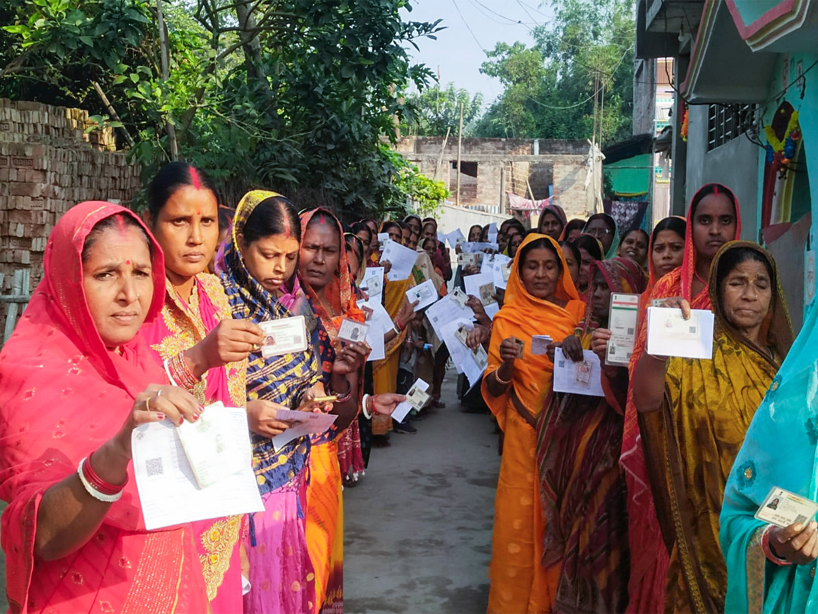 Woman voters wait in a queue to cast their vote in Katihar