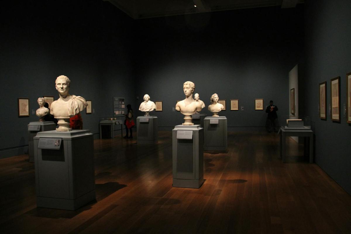 assorted busts on gray stand