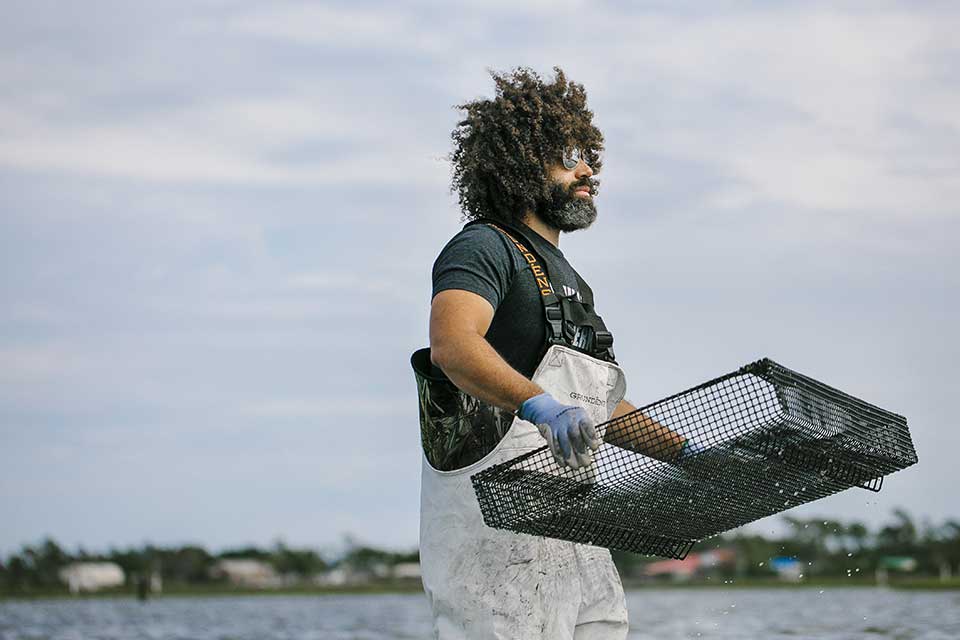 Oyster farmer Ryan Bethea. Photo by Jeyhoun Allebaugh.
