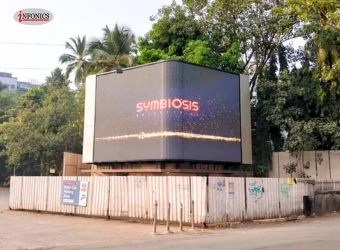 Large curved screen LED wall installed outdoors, showing vibrant digital content.