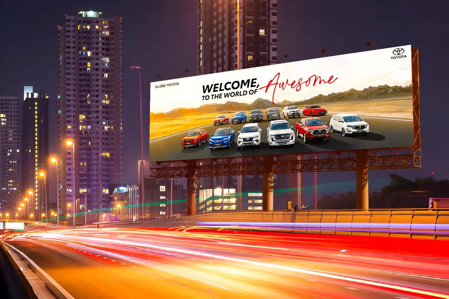 Highway billboard showcasing Toyota fleet on elevated road with motion blur traffic lights