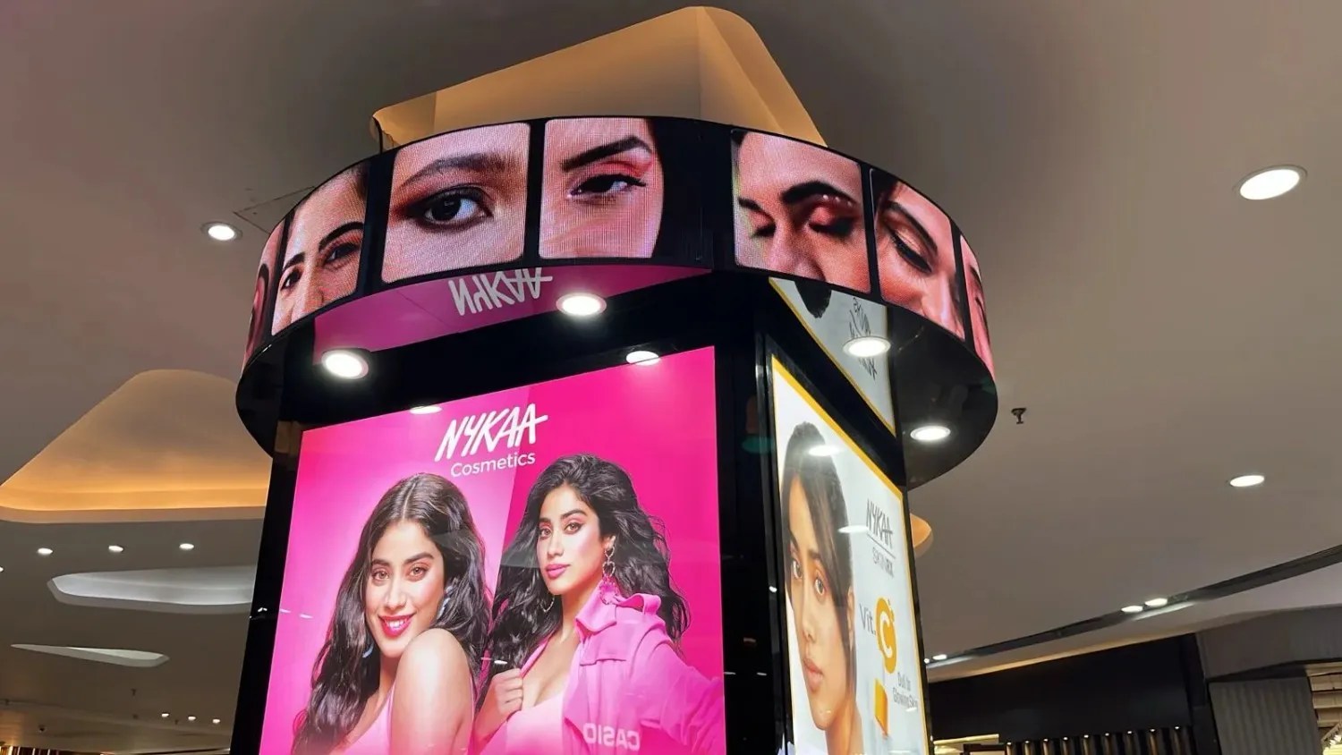 Curved indoor LED display and digital retail signage showcasing Nykaa Cosmetics promotions inside a shopping mall, featuring high-resolution makeup visuals and dynamic advertising content.
