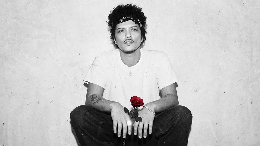 Bruno Mars performing live with vibrant stage lights during The Romantic Tour 2026.