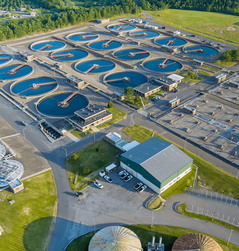 Overhead perspective of a large water treatment facility, featuring extensive tanks and processing areas for water purification.