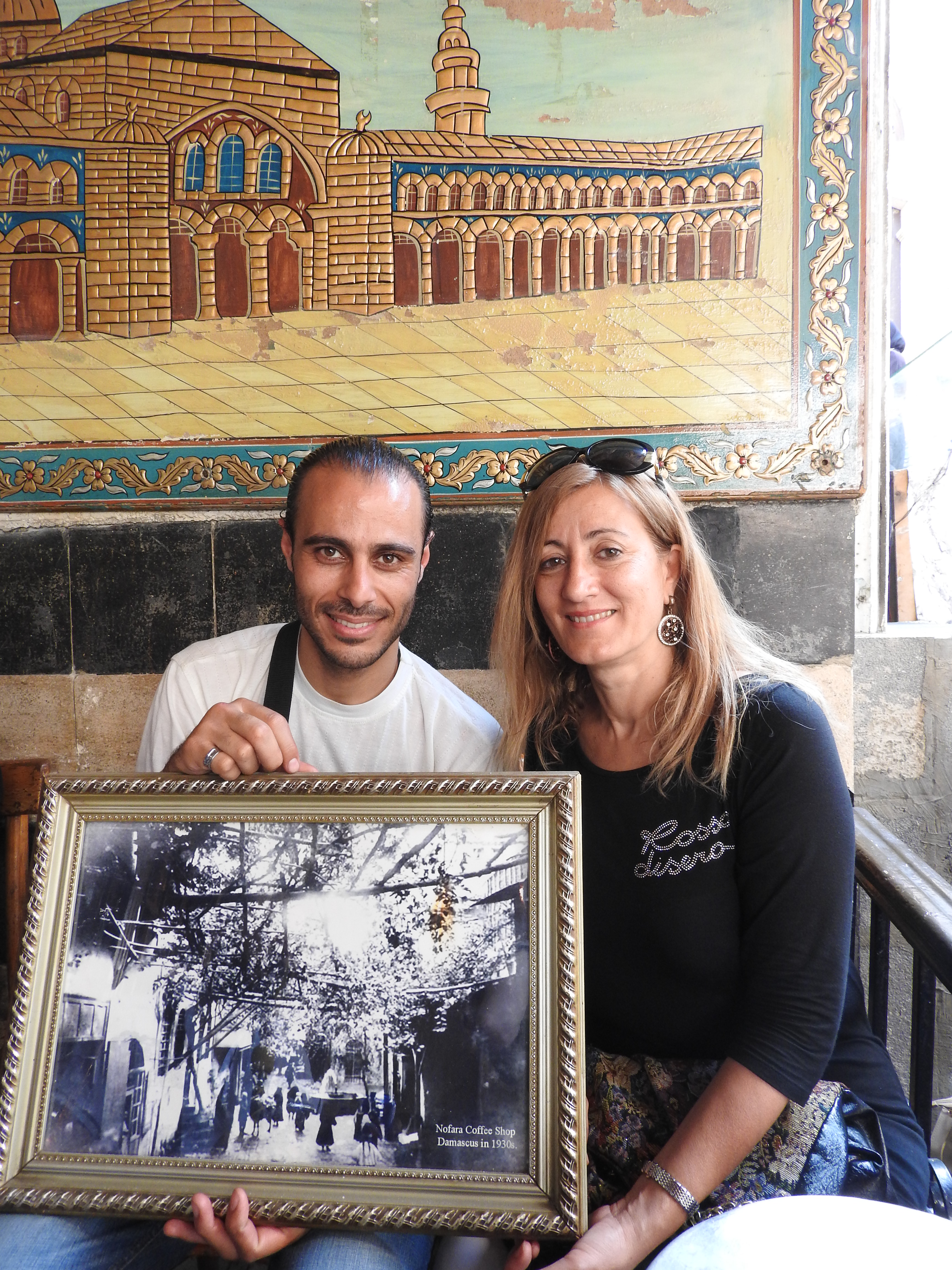 Two Syrian friends in an old cafe, old Damascus. They tell me, he is Alawi, she is Sunni, they are close friends. I hear this everywhere I go in Syria.