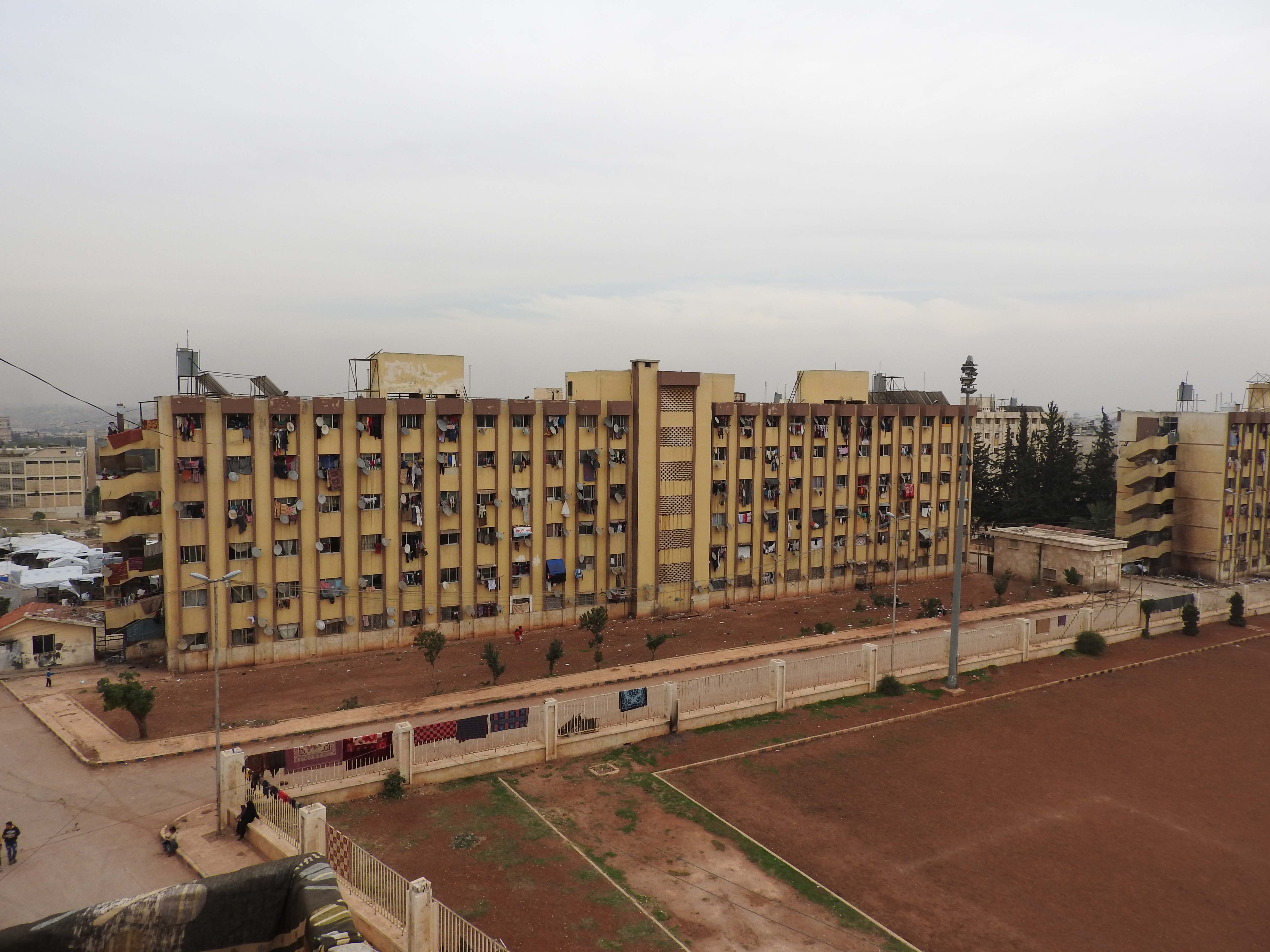 At the time I visited, in November 2016, Aleppo University residences had been housing well over 10,000 internally displaced Syrians from areas of Aleppo and its countryside for around 4 or more years. One of the residences was hit by a terrorist missile the week prior, killing four from one family. While at the Aleppo University residences, a woman stopped me to say hello. She spoke very articulately, about the situation in Aleppo (see: https://www.youtube.com/watch?v=OD2QCZjBSX4). From: https://ingaza.wordpress.com/2016/11/24/overview-of-latest-month-long-visit-to-syria-aleppo-and-damascus/