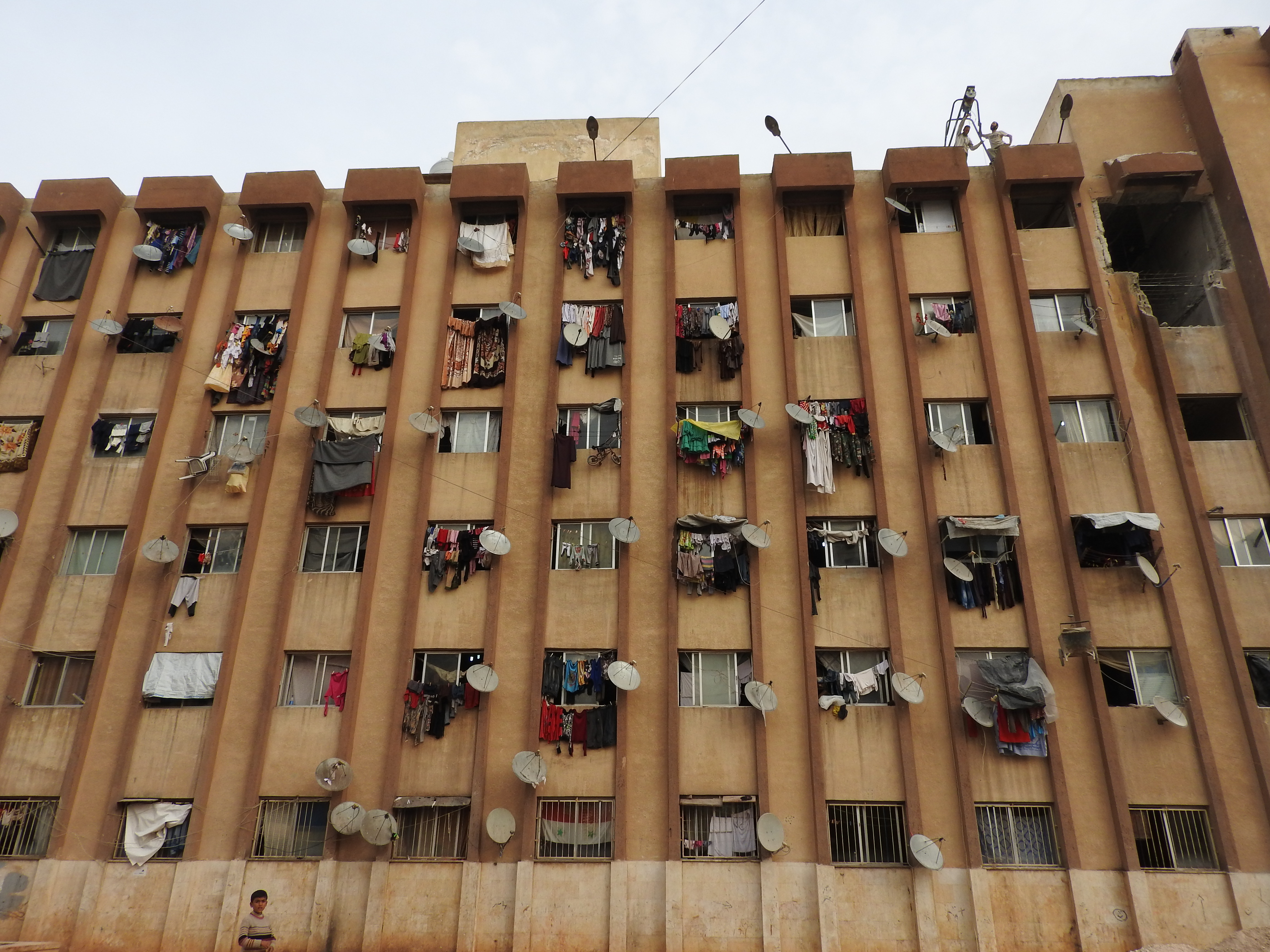 At the time I visited, in November 2016, Aleppo University residences had been housing well over 10,000 internally displaced Syrians from areas of Aleppo and its countryside for around 4 or more years. One of the residences was hit by a terrorist missile the week prior, killing four from one family. While at the Aleppo University residences, a woman stopped me to say hello. She spoke very articulately, about the situation in Aleppo (see: https://www.youtube.com/watch?v=OD2QCZjBSX4). From: https://ingaza.wordpress.com/2016/11/24/overview-of-latest-month-long-visit-to-syria-aleppo-and-damascus/
