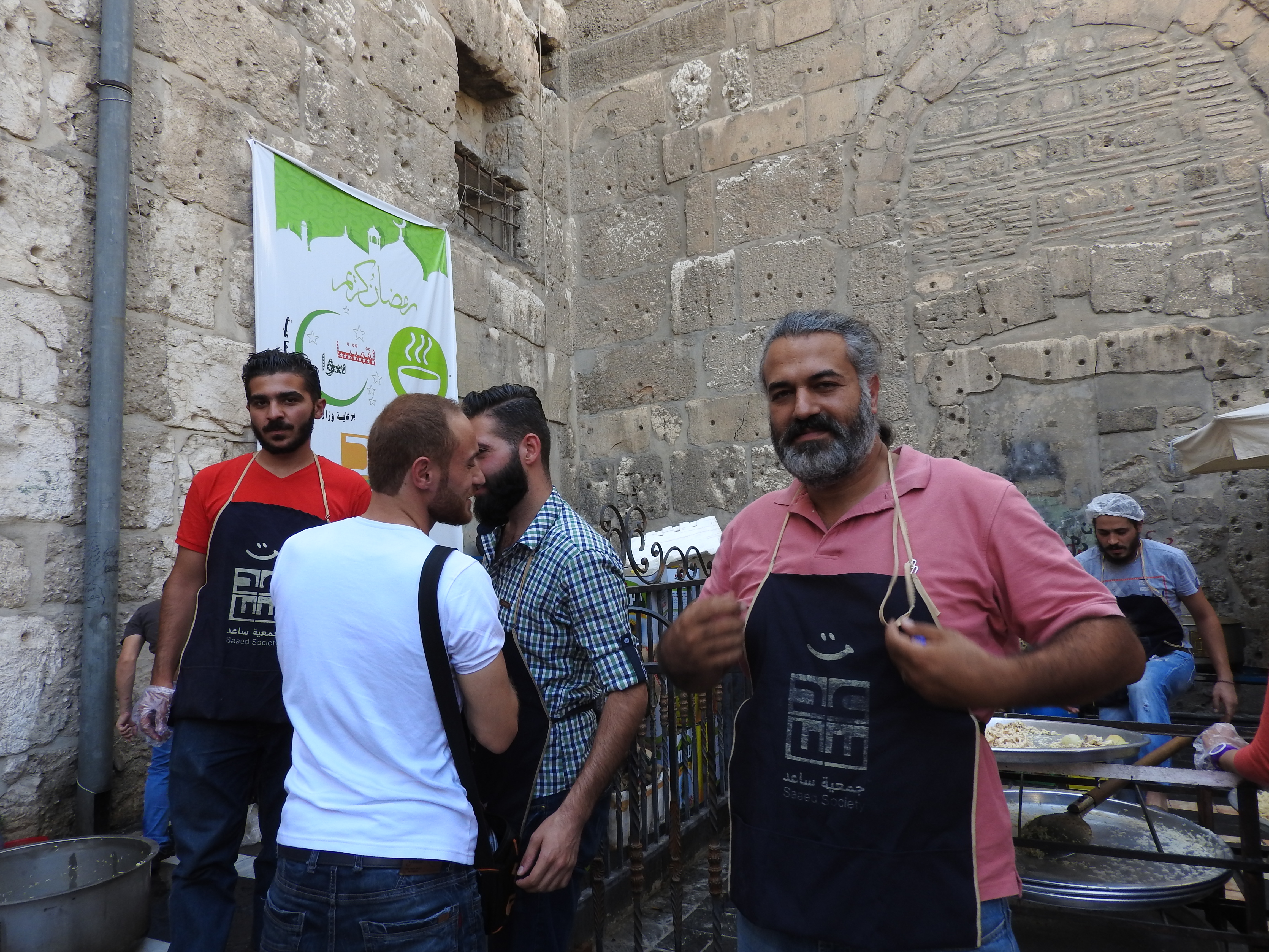 Fadi Assi (a Christian) joins other Saaed volunteers to cook for Damascus' poor during Ramadan.