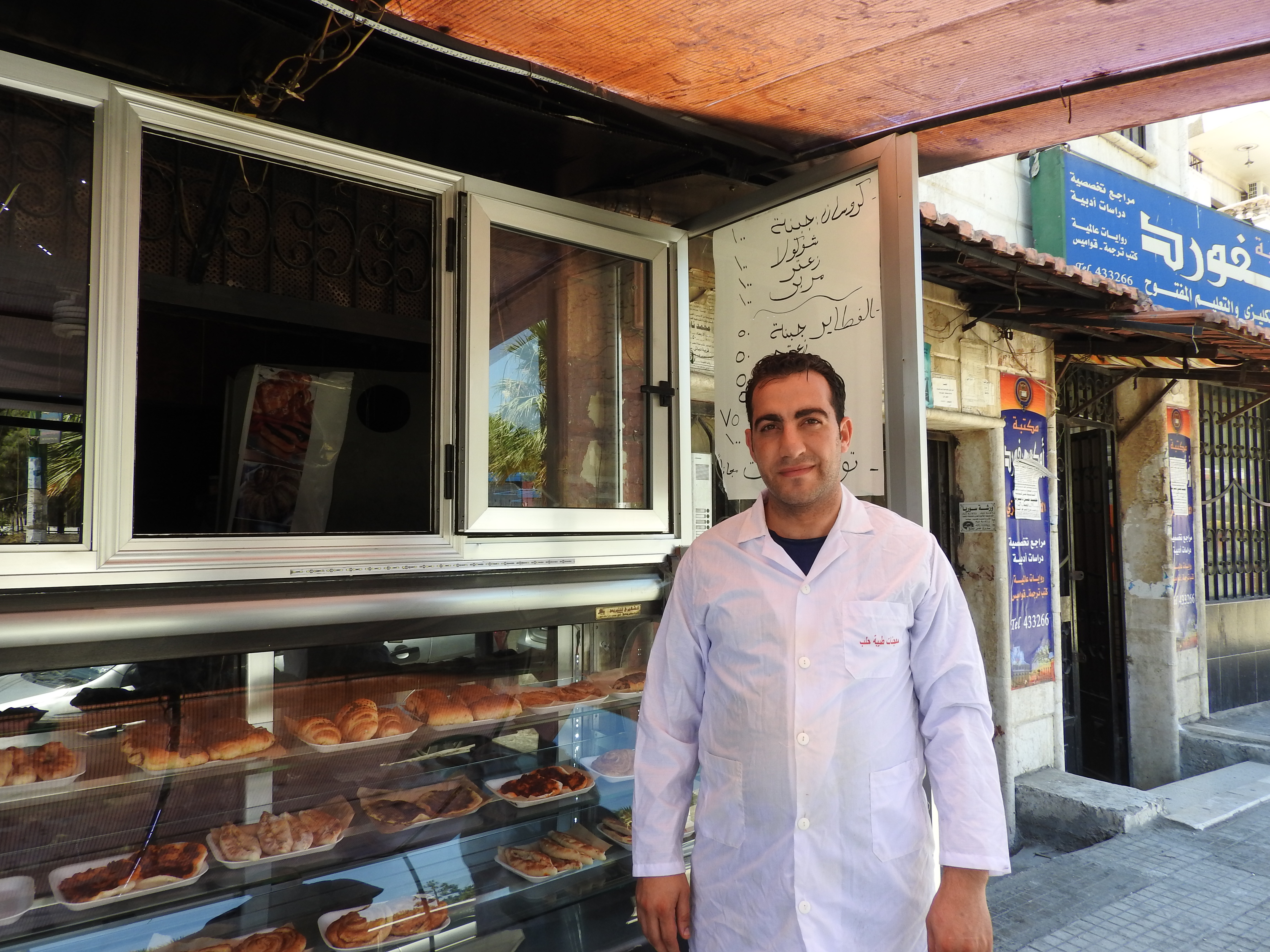Croissant shop owner is displaced from Aleppo, from one of the first areas to be infested by terrorists. He lost he three apparently very-well known and loved croissant/bakery shops, all the equipment, his home and all furnishings when he and family fled the terrorists to Latakia. His personal loss also of course affected the 10 employees he had in Aleppo. Here, he worked for about 4 months in Jableh before opening his first croissant shop in Latakia, which has since blossomed into two apparently very popular croissant shops. More here: https://ingaza.wordpress.com/2016/08/11/updates-from-on-the-ground-in-syria-june-to-august-11/ or here: https://www.facebook.com/EvaBoBeeva/posts/1244053205604671