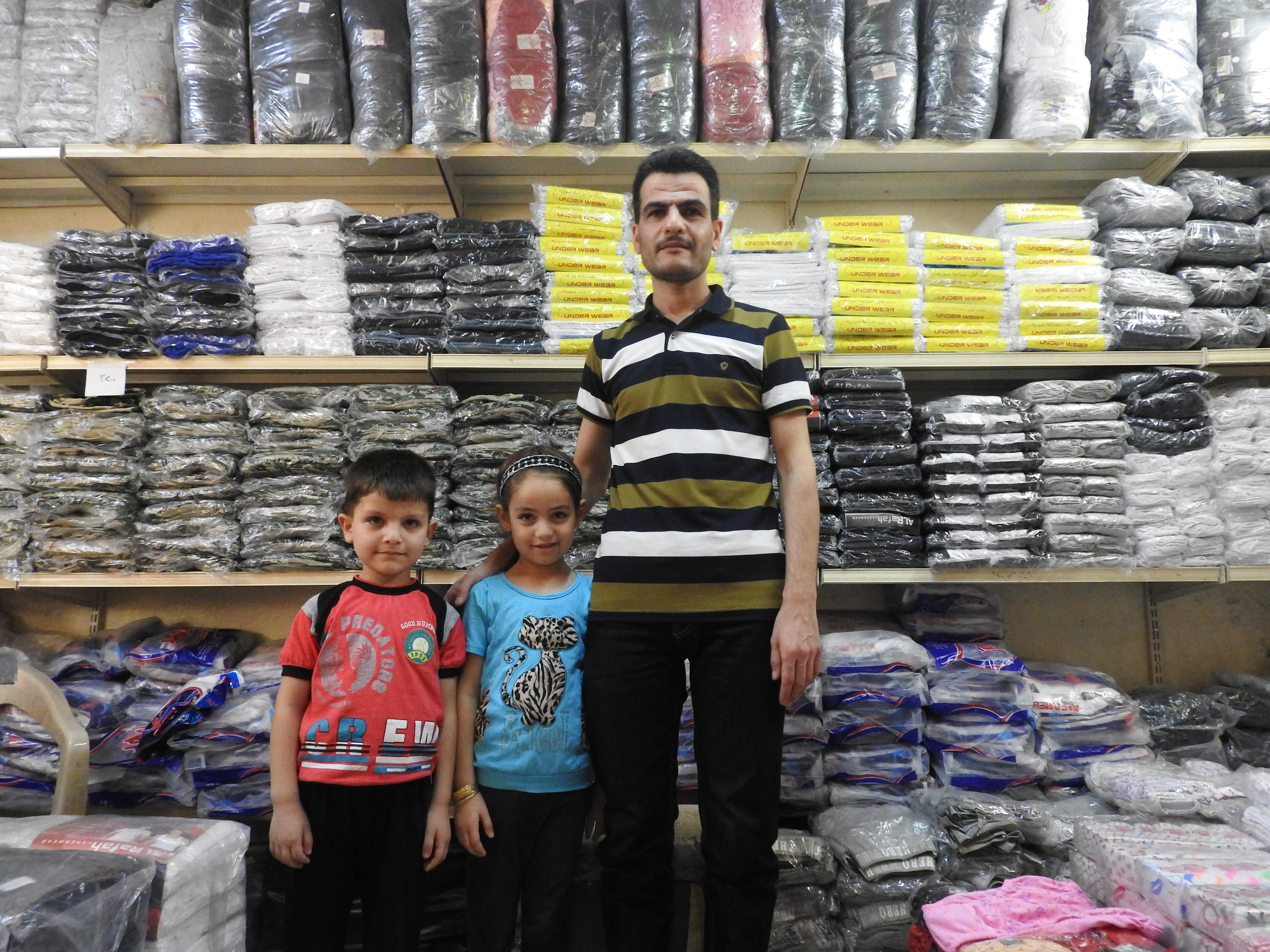 Shop owner fled an of Aleppo when terrorists invaded, losing his garment factory (where 76 people worked), all of the equipment inside (including 40 machines), and his shop in the Old City of Aleppo, which like the factory was looted by western-backed "freedom-loving" "moderate-rebel" terrorists. He re-opened in Latakia, starting slowly, first getting a small space in one of the markets here and selling others' clothes, then acquiring a small workshop to manufacture his own again. His story is filled with sadness and loss, including a 20 day old son...of kidnappings by the thugs the west calls "rebels", and also of the steadfastness exhibited by Syrians over and over during this dirty war on the sovereign nation. I often ask simple questions to allow Syrians to speak their opinions. My question about the role of the SAA was met with this reply: "If you have a chicken, and a snake is attacking it, aren't you going to attack the snake to save the chicken?" More here: https://ingaza.wordpress.com/2016/08/11/updates-from-on-the-ground-in-syria-june-to-august-11/